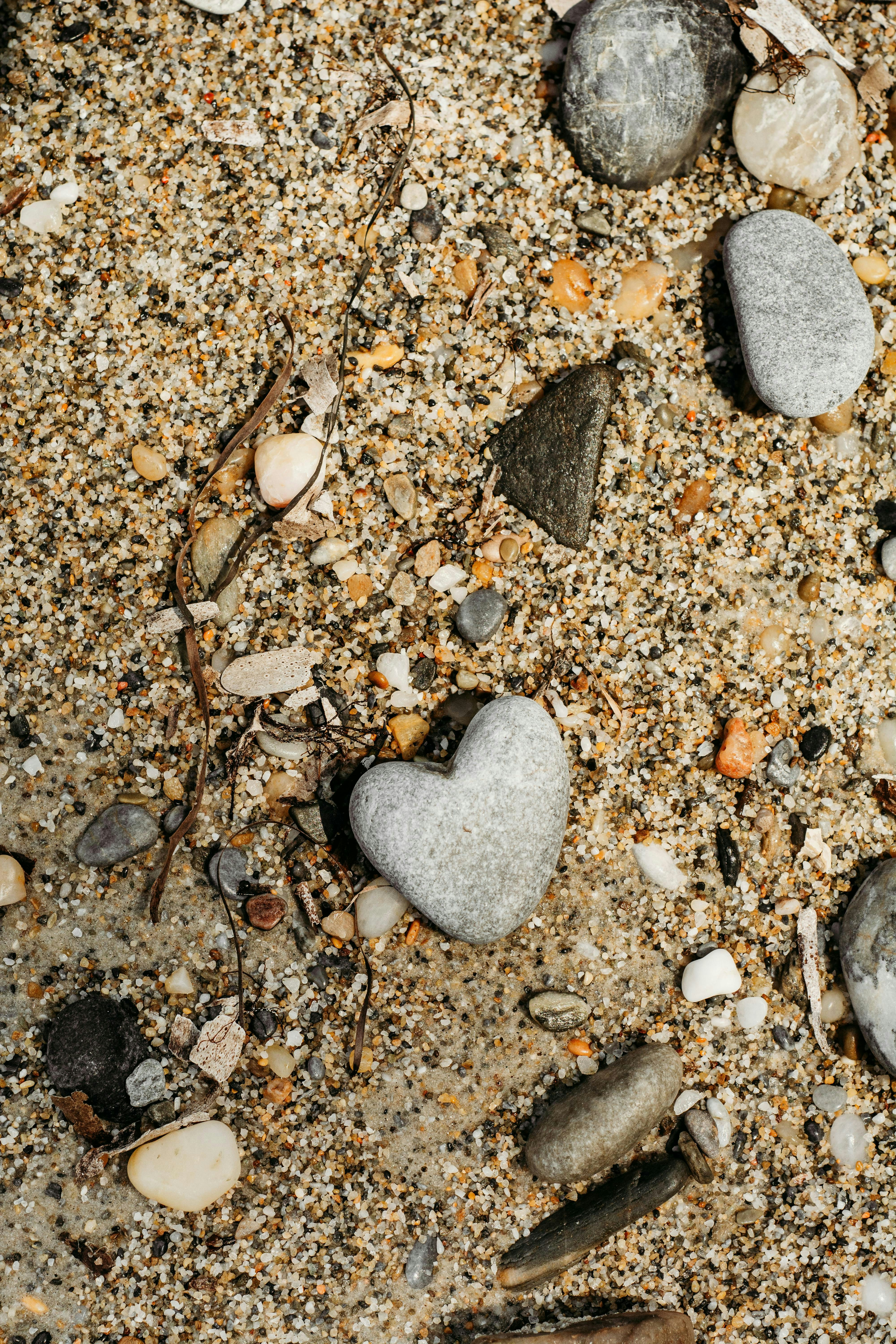 Heart-shaped rock in sand